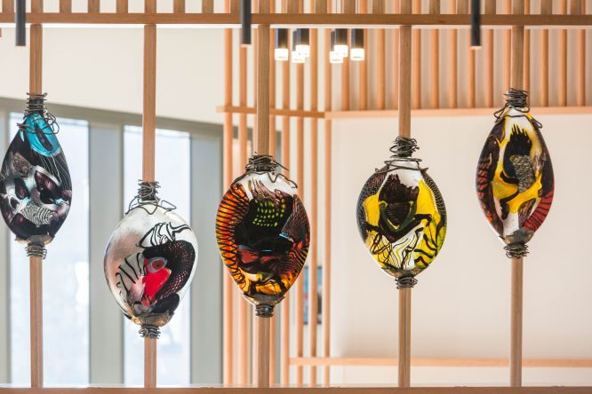 Black cockatoo-inspired lown glass works by Noel Hart feature in the Elements of Byron reception area. Photo: Supplied.