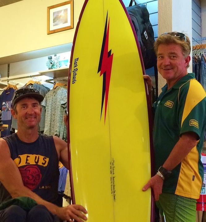 Dave Munk and Mark "Mono" Stewart with the $2500 hand-signed Mark Richards surfboard which will be one of the fundraiser major prizes.